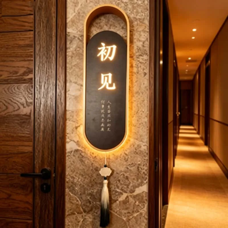 Warm halo-lit vertical hotel and hospitality sign