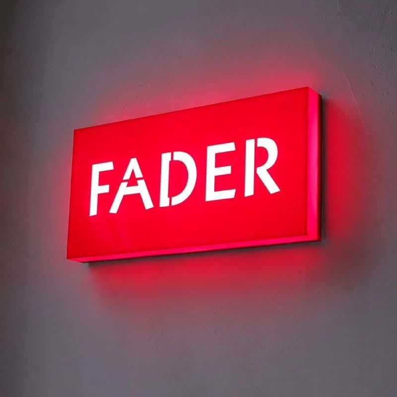 Red indoor LED light box sign mounted on a smooth wall