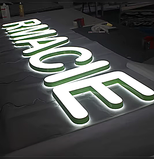 Face-lit acrylic channel letters illuminated during fabrication testing