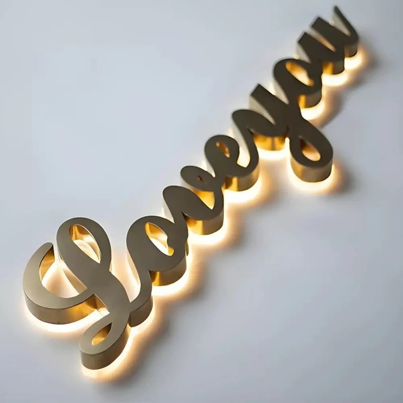 Gold stainless steel script sign on a wall