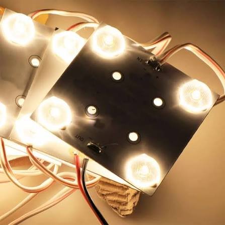 Illuminated LED module board demonstrating lens output and thermal layout