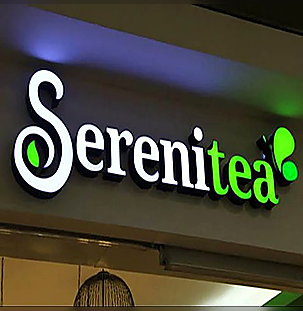 Illuminated storefront letters showing readable logo and wordmark proportions