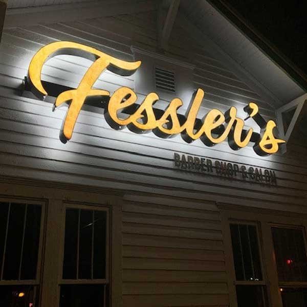 Installed illuminated channel letter sign showing organized mounting