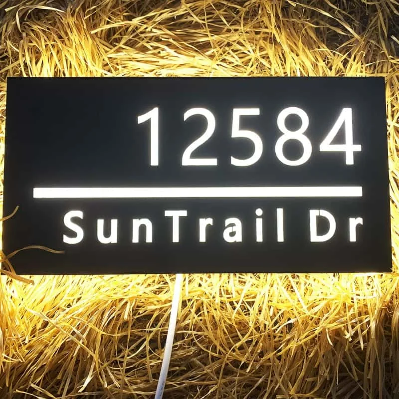 Illuminated address light box in an outdoor setting