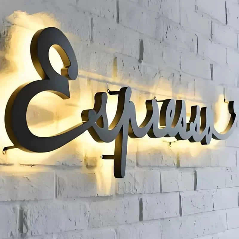 Warm white script halo letters mounted on a wall