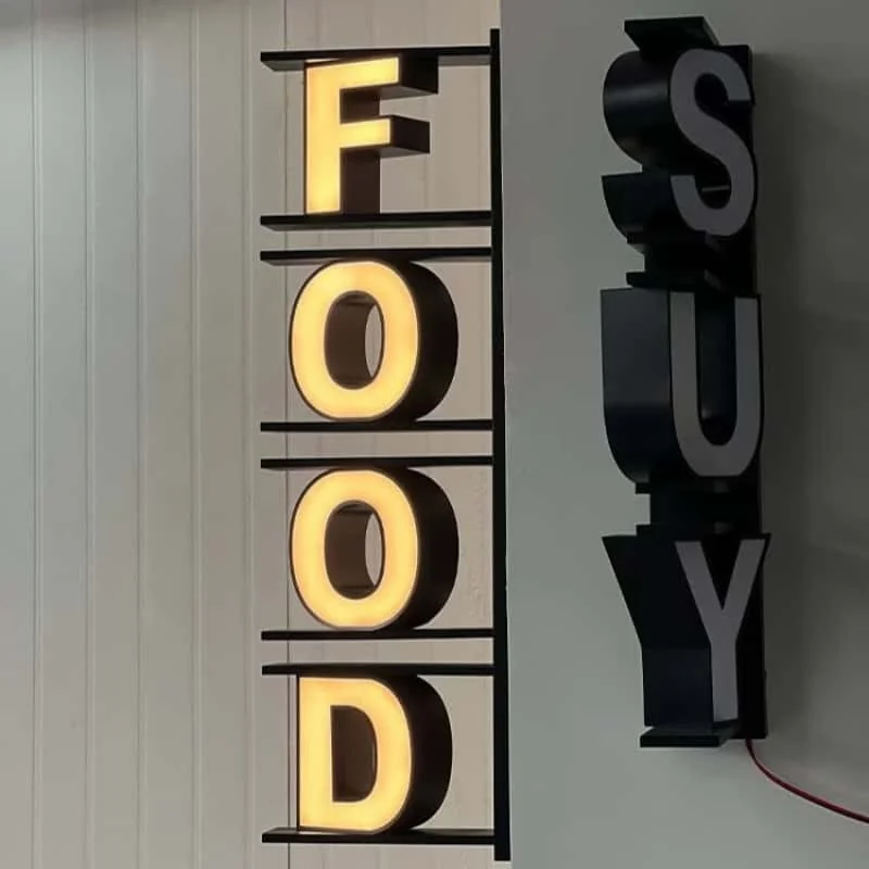 Vertical FOOD letter sign with illuminated and unlit views