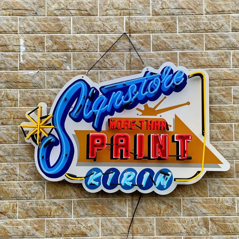 Colorful illuminated outdoor logo sign mounted on brick