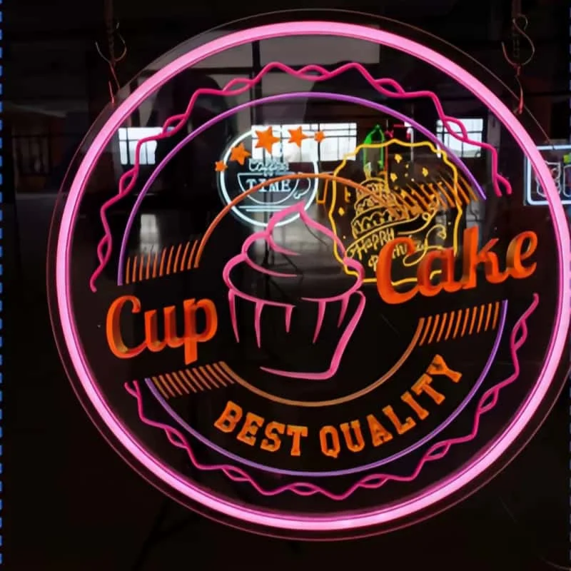 Pink outdoor-style neon cafe sign on a dark background