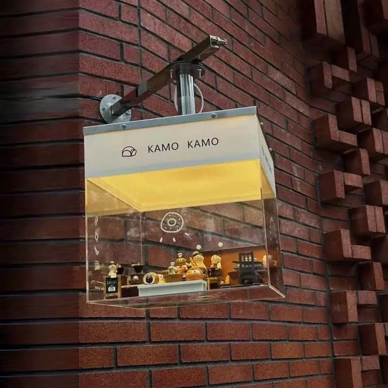 Projecting café light box on a brick wall