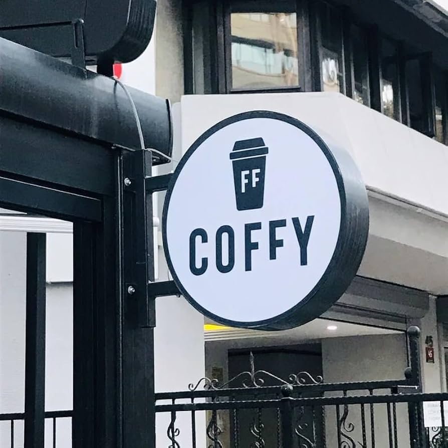 Round outdoor coffee shop projecting sign with metal return