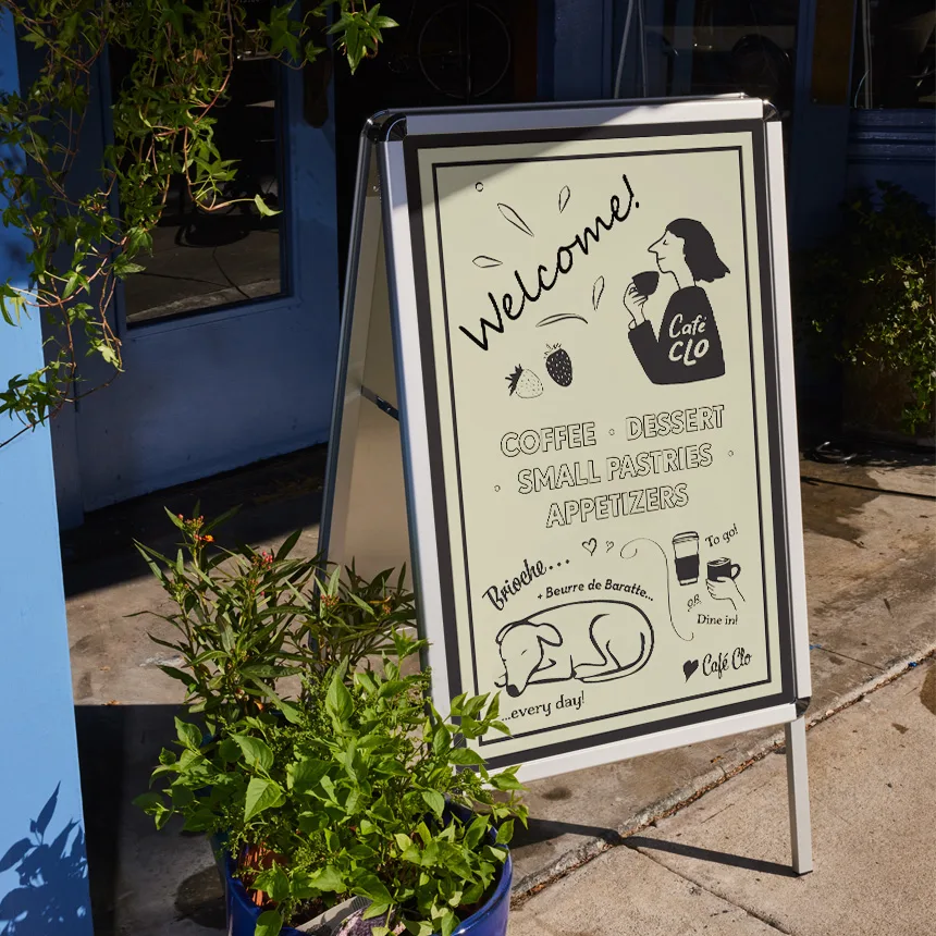 Portable outdoor sidewalk sign at a commercial storefront