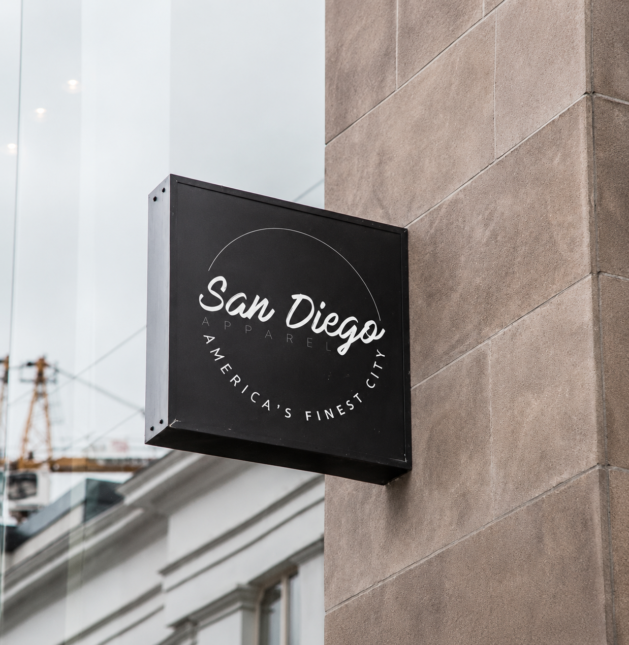 Square metal projecting sign with concealed wall mounting