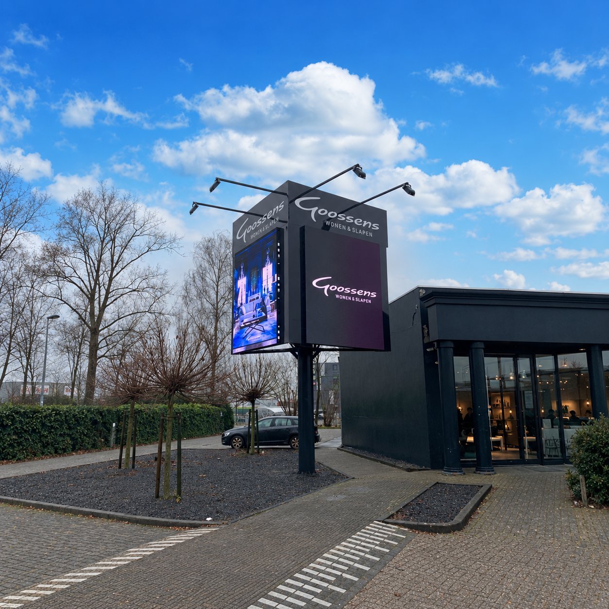 Roadside LED Pylon Display Outdoor double-sided LED pylon display beside a retail entrance.