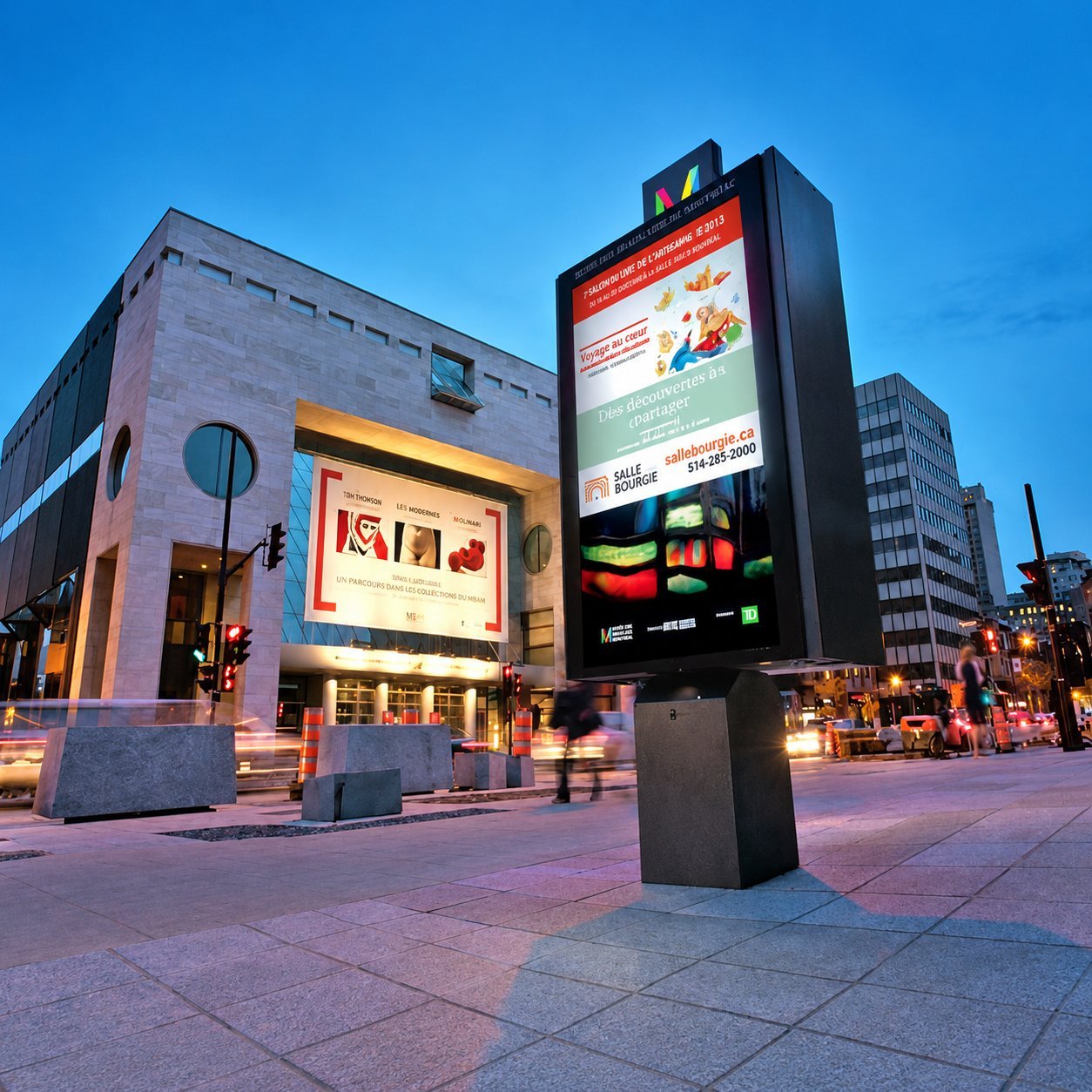 Building Exterior LED Display Tall LED display on a building exterior with event listing content.