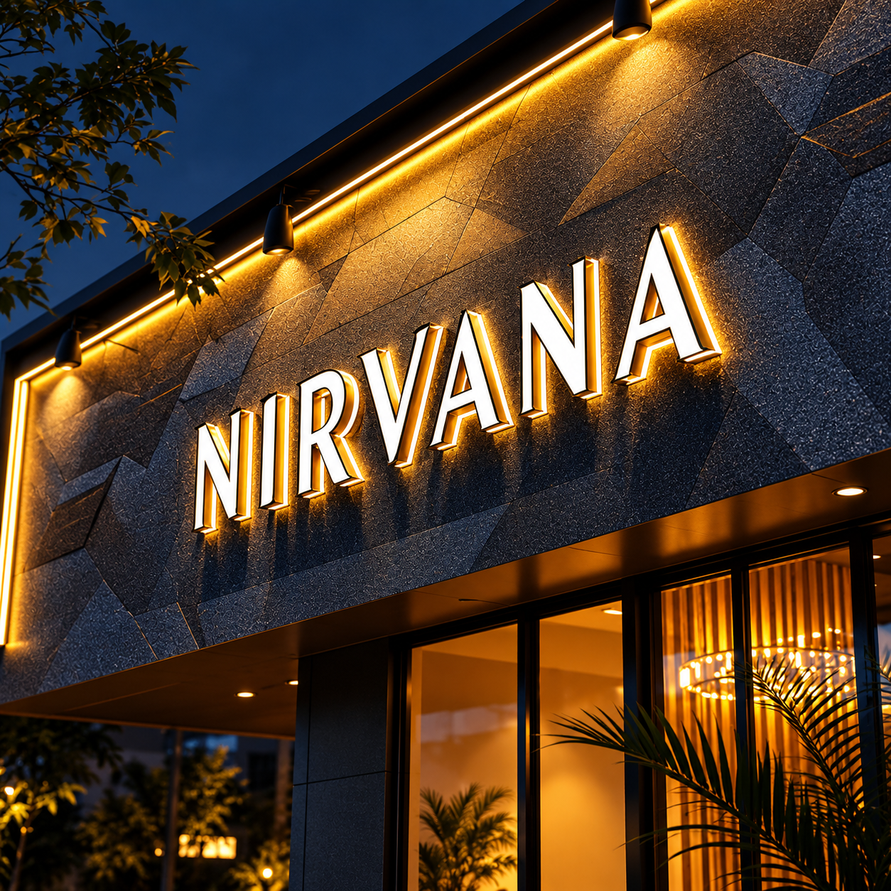 Warm illuminated Nirvana wall sign with raised letters on a dark exterior facade.