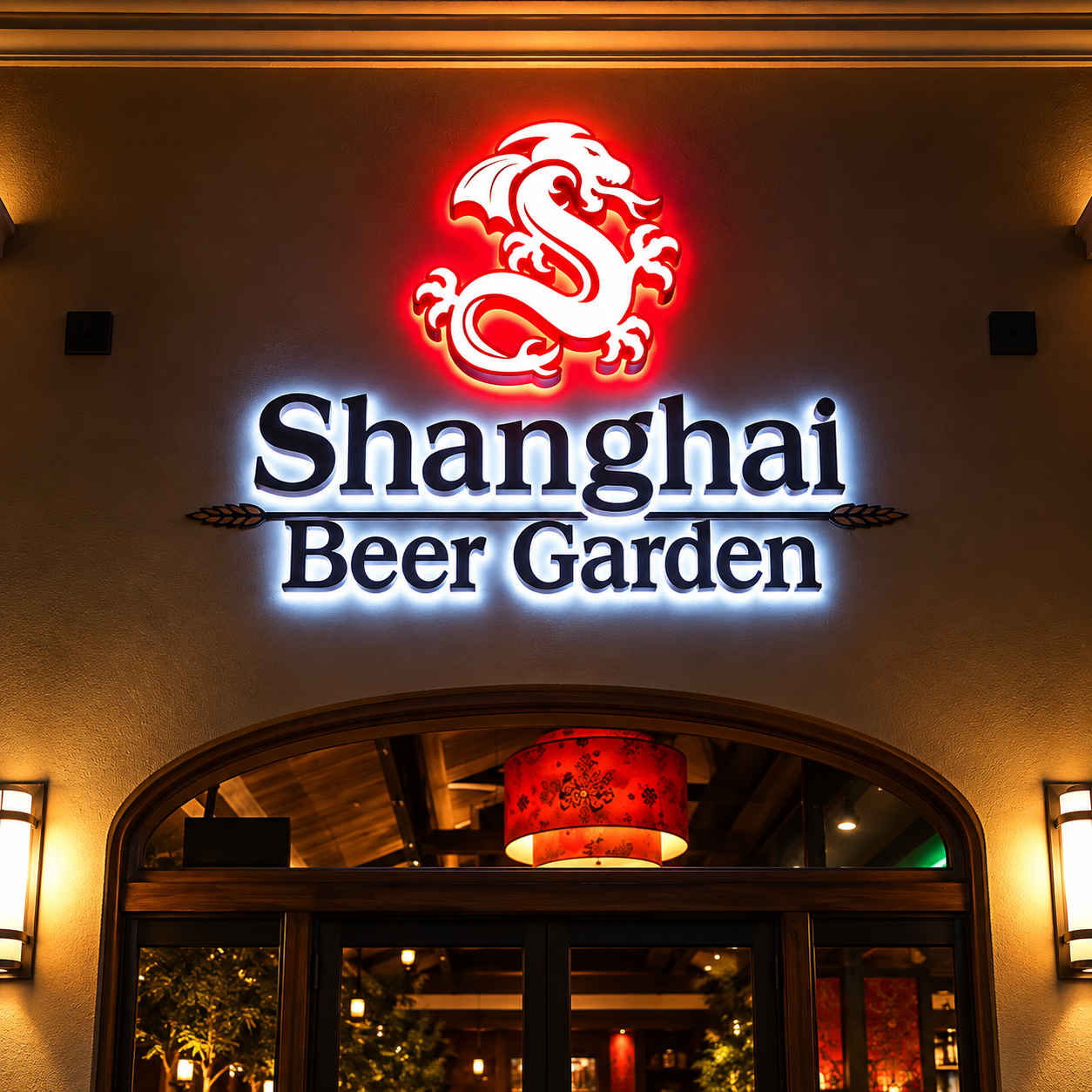 Illuminated Shanghai Beer Garden restaurant sign above an entrance at night.