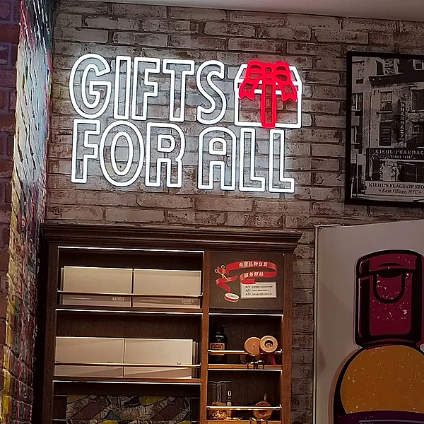 LED neon-style storefront sign in white outline mounted on a brick wall