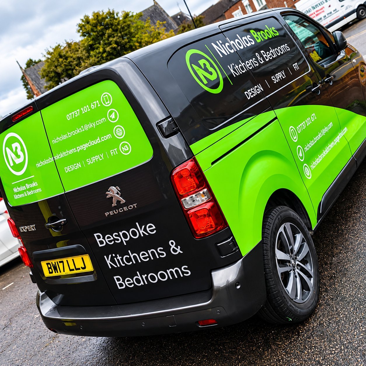 Commercial vehicle wrap with branded graphics and contact details