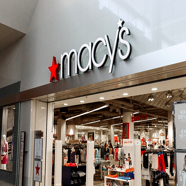 Dimensional storefront letters and red star logo at a department store mall entrance